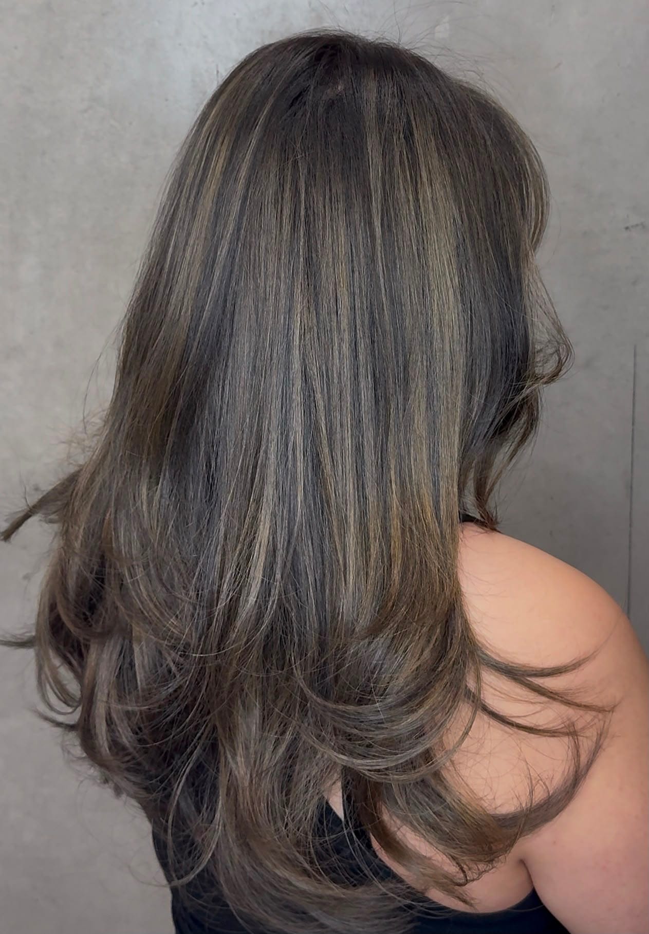 Ash brown balayage with soft highlights and long layers by UNIK Hair Design