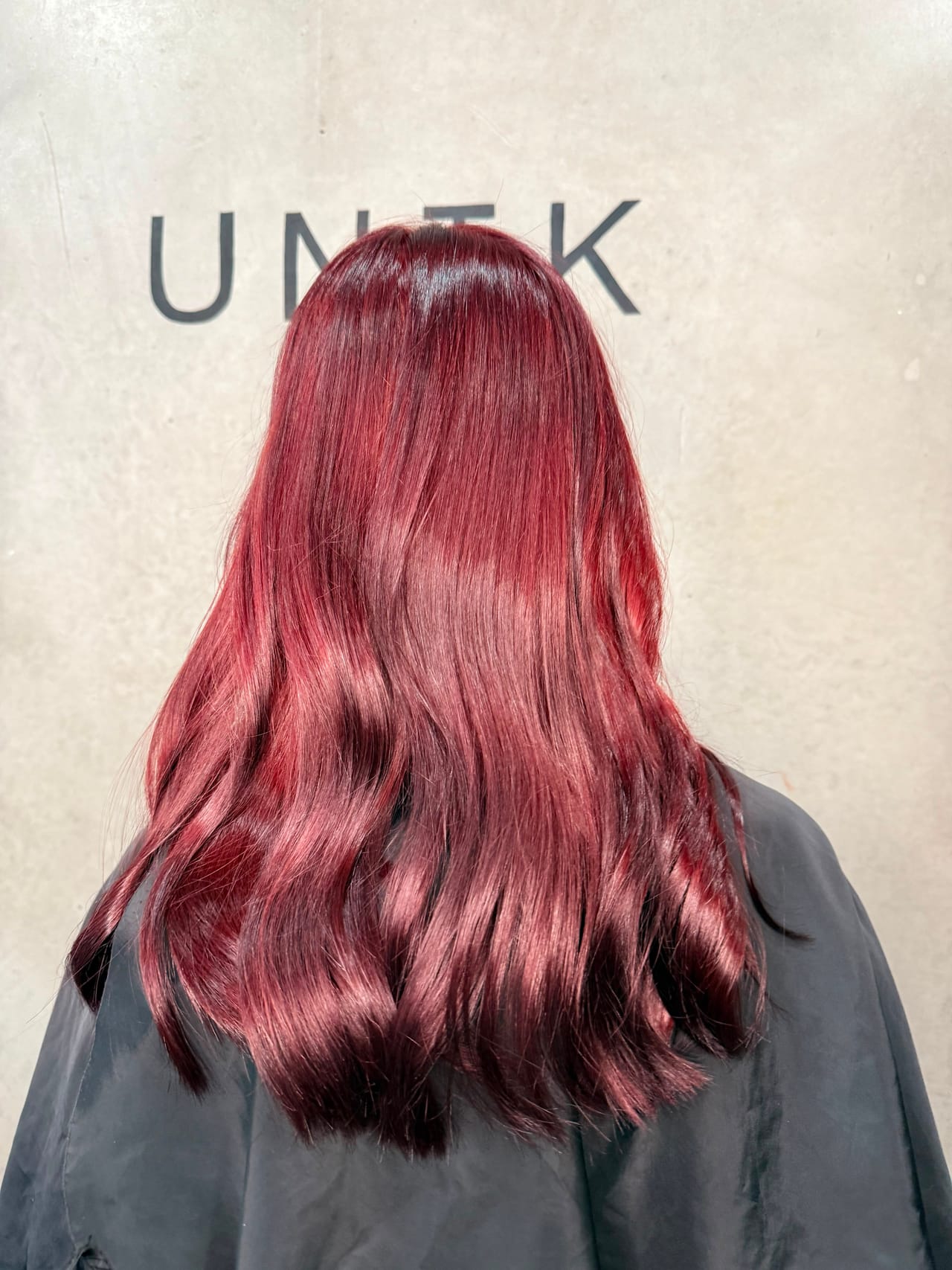 Deep cherry red hair colour with long waves by UNIK Hair Design